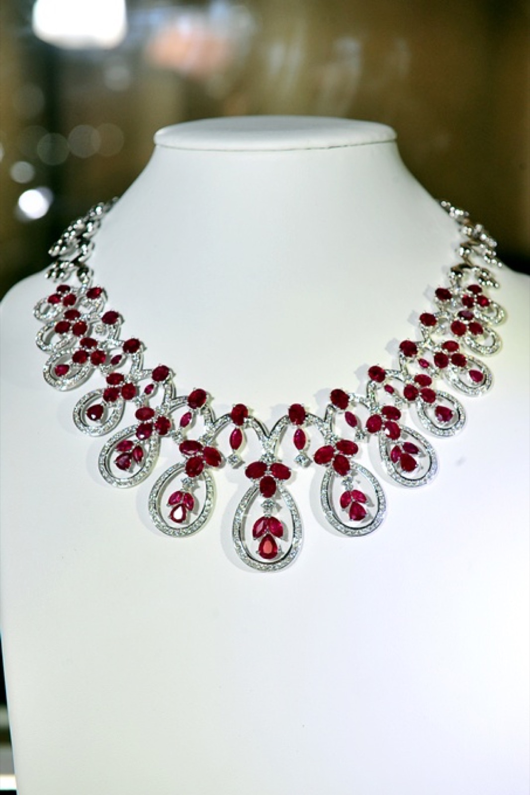 A necklace of rubies and diamonds on a display bust at the couture evening