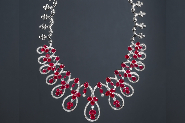 A cascade of rubies framed by brilliant cut diamonds