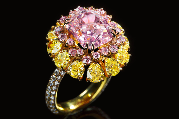 A blossom of pink and yellow diamonds set in white gold.