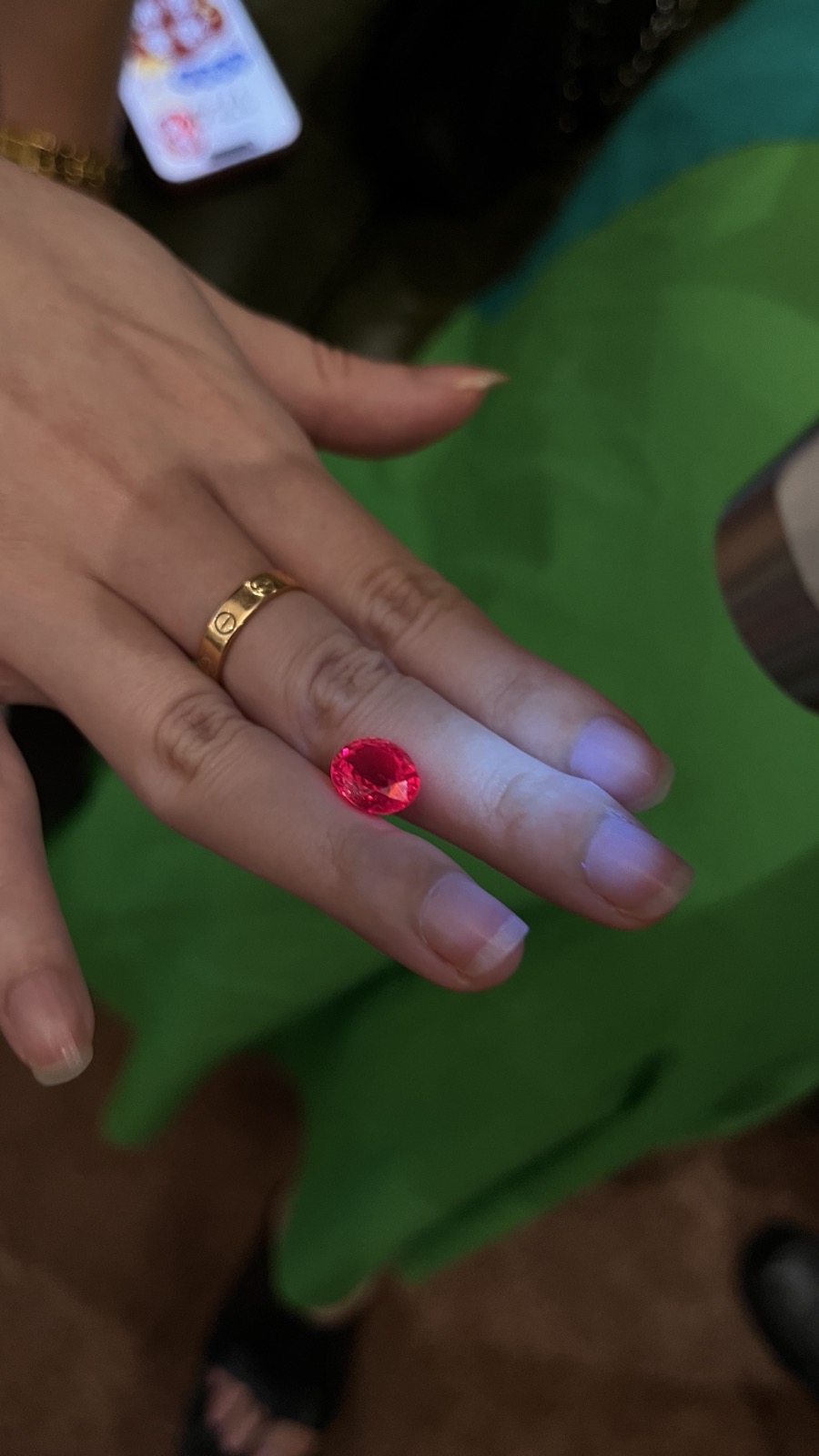 The house's 6 carat natural Jedi spinel, glowing against the light